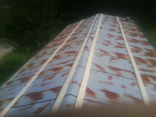 Rusted metal roof panels with new wood purlins before replacement — Storm Damage Roof Repair in Notus by Roofing Brothers